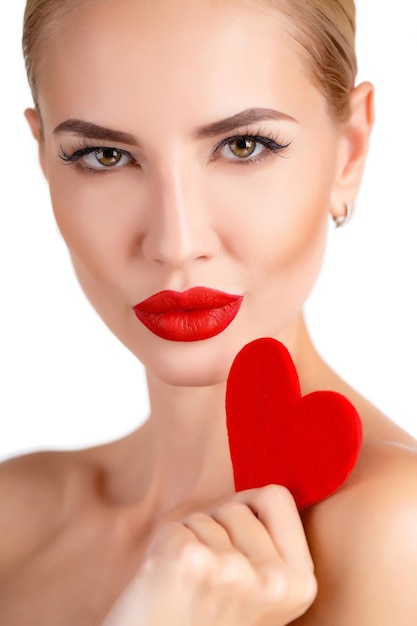 beautiful woman with a heart indoor isolated