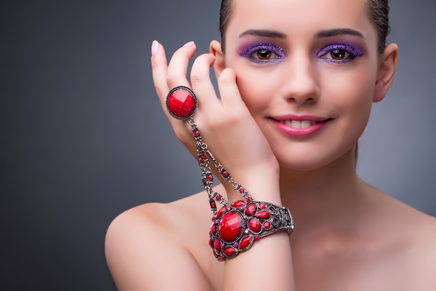 Beautiful woman with jewellery in fashion concept