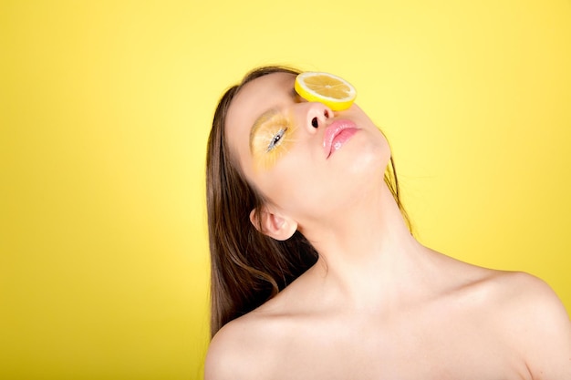 Beautiful woman with lemon and yellow makeup