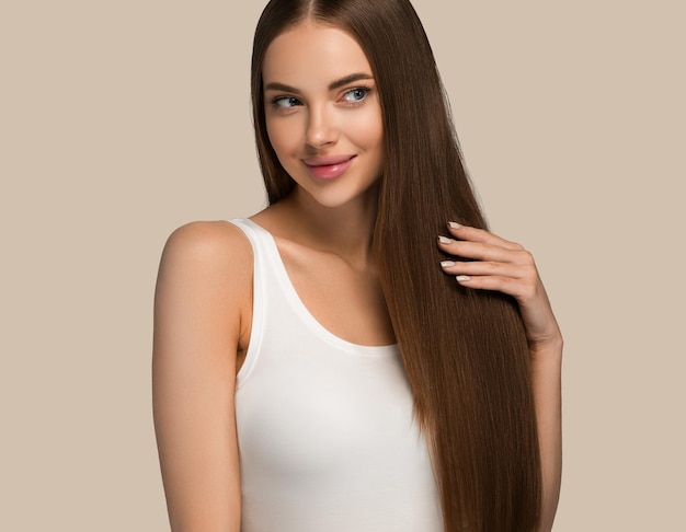 Beautiful woman with long healthy smooth hair beauty natural casual style. Color background brown