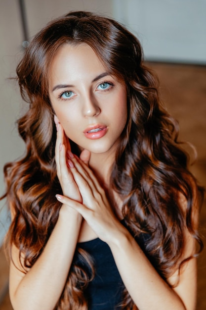 Beautiful woman with long wavy hair beauty makeup and cosmetics