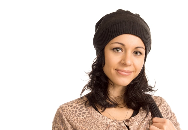 Beautiful woman with a lovely smile wearing a knitted winter hat head and shoulders portrait isolated on white