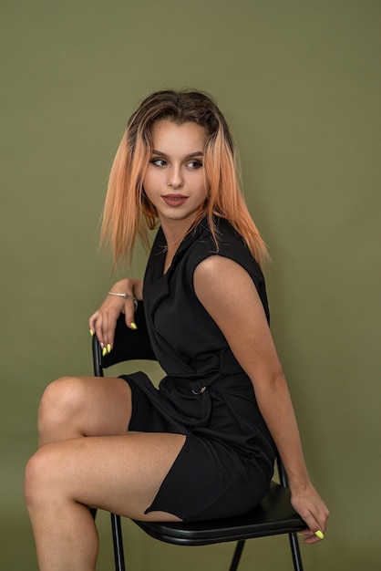 Beautiful woman with luxurious hair in a classic dress on a beautiful background Shooting concept for girls