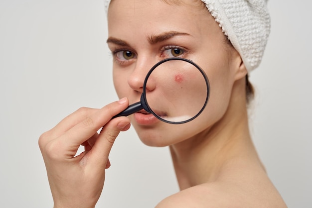 Beautiful woman with a magnifying glass in hand hygiene treatment