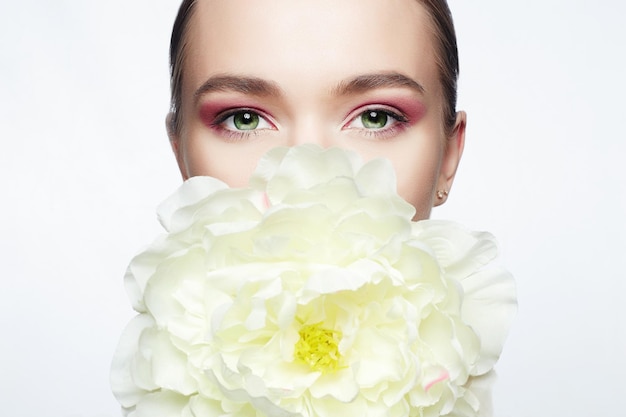 Beautiful Woman with Makeup and Flower