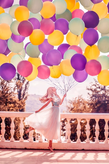 Beautiful woman with many balloons