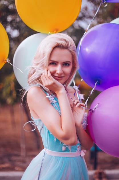 Beautiful woman with many balloons