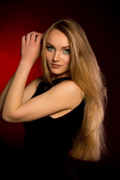 Beautiful woman with natural makeup and lush blonde hair at studio