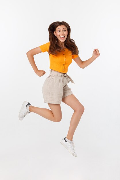 Beautiful woman with orange blouse jumping