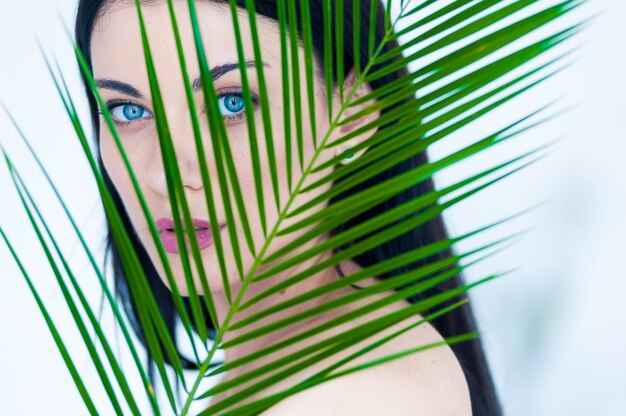 Beautiful woman with palm leaves