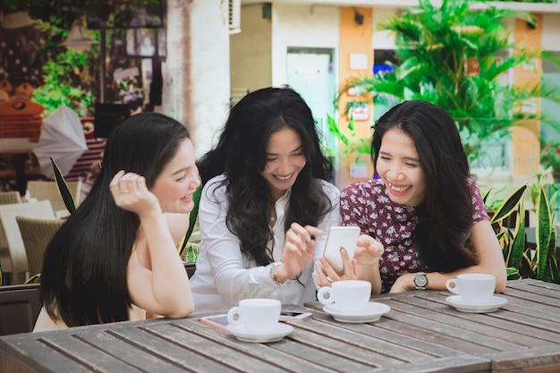 Beautiful woman with phone and her friends