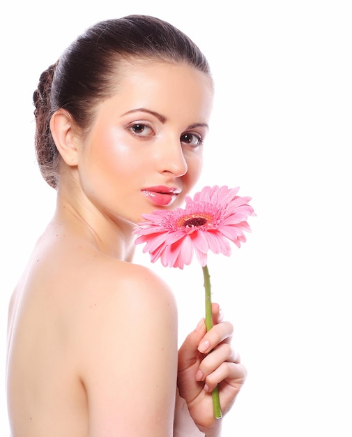 Beautiful woman with pink flower isolated on white