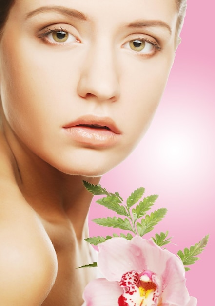 Beautiful woman with pink flower