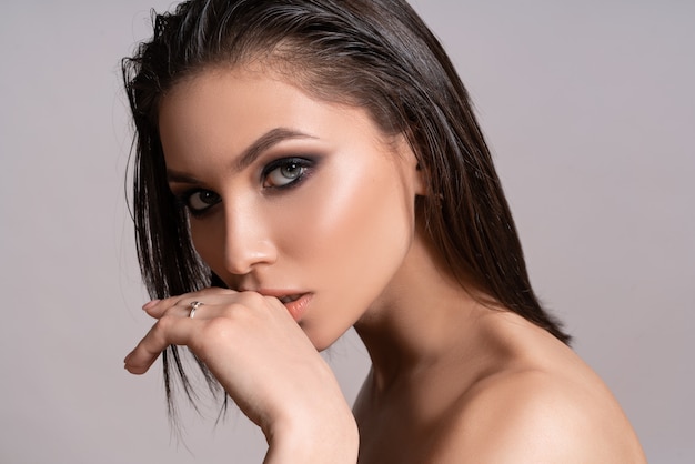 Beautiful woman with professional make-up posing