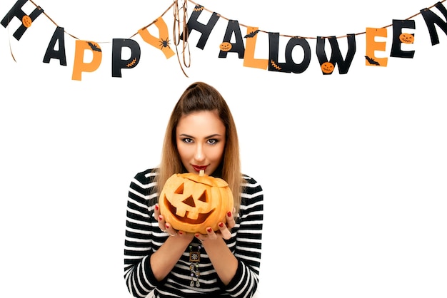 beautiful woman with pumpkin in Halloween decoration