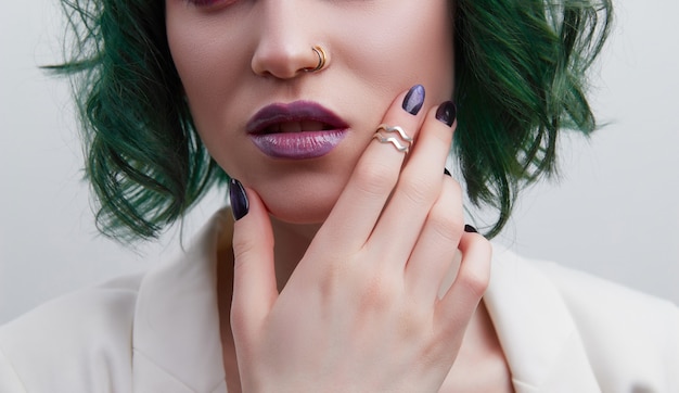 Beautiful woman with purple green professional colored hair bright eyes and lips makeup