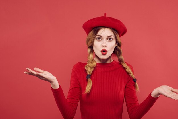 Beautiful woman with a red cap on his head glamor isolated\
background