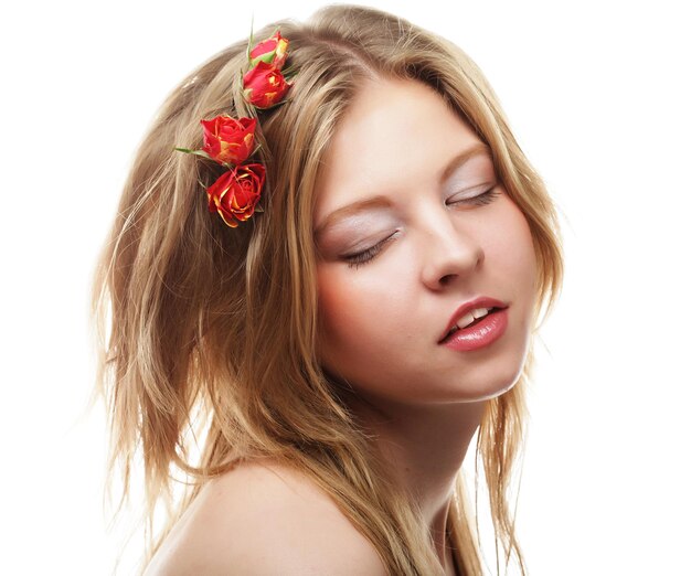 Beautiful woman with red flowers in the hairs