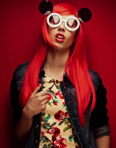 Beautiful woman with red hair wearing big sunglasses