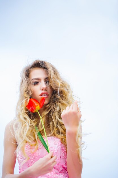 Beautiful woman with red tulip