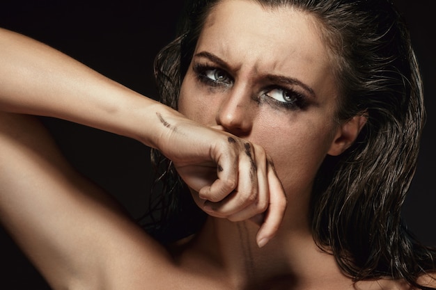 Beautiful woman with smudged makeup on her face