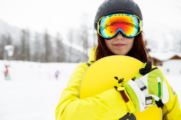 Beautiful woman with a snowboard