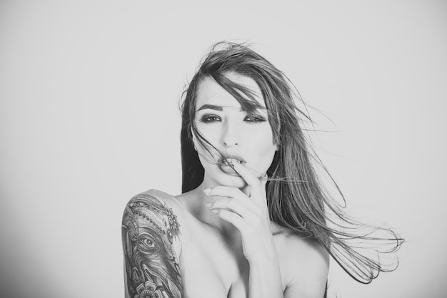 Beautiful woman with tattoo on shoulder