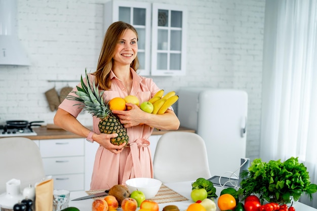 Beautiful woman with vegeterian food Attractive young female holding tasty vegetables