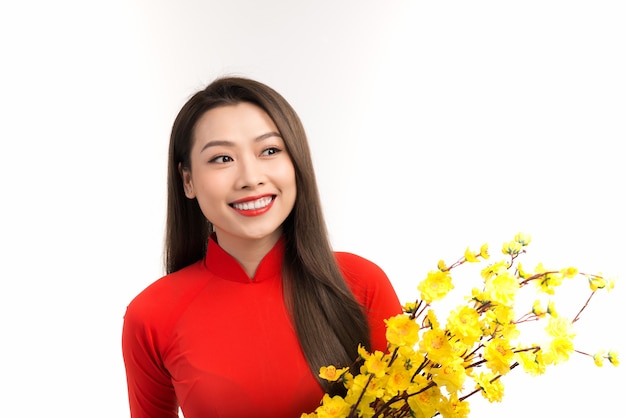 Beautiful woman with Vietnam culture traditional dress, holding Apricot blossom over white