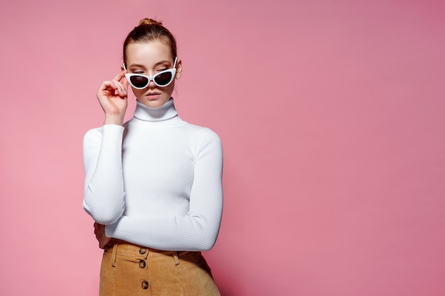 Beautiful woman with white sweater posing