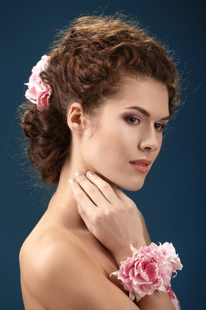 Beautiful woman with a wreath and decoration on the hand.