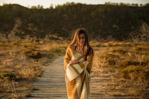 Beautiful woman wrapped in a wool towel