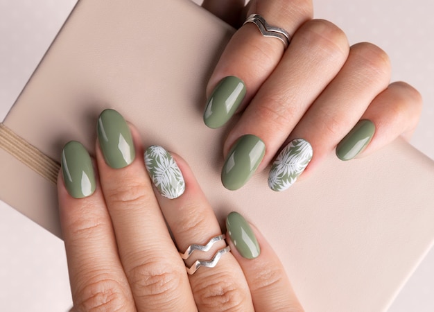 Beautiful womans hands with spring summer floral nail design