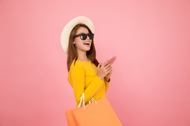 Beautiful women are shopping in the summer with blue paper bags