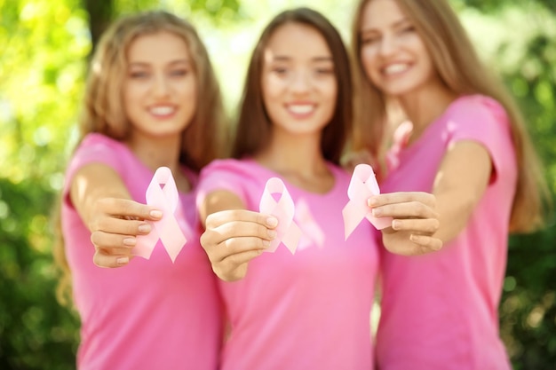 Beautiful Women Holding Symbols of Breast Cancer Awareness