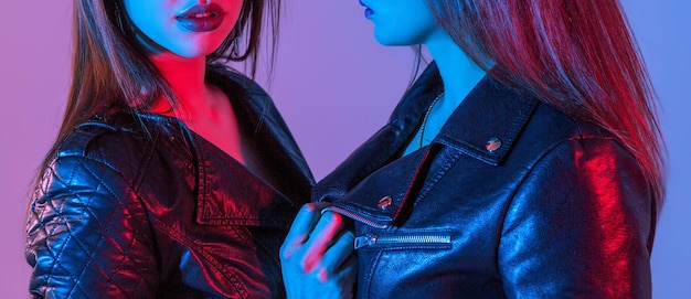 Beautiful women in leather jackets with studio lights