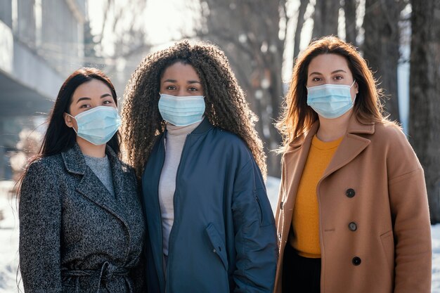 Beautiful women posing together with mask