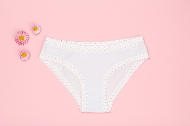 Beautiful women's cotton panties on pink background.