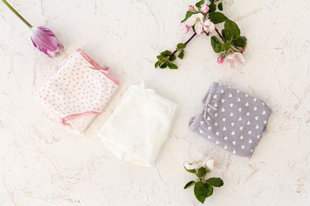 Beautiful women's cotton panties on white background with flowers.