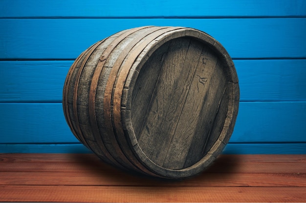 Beautiful wooden barrel on a red wood table and blue wood wall background