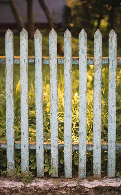 beautiful wooden fence in the village in the contrast sunlight