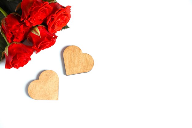 Beautiful wooden hearts with a red bouquet of roses