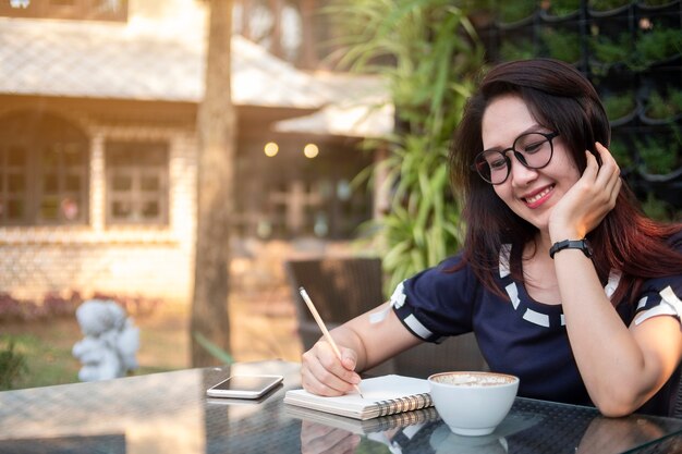 Beautiful working woman write on notebook 