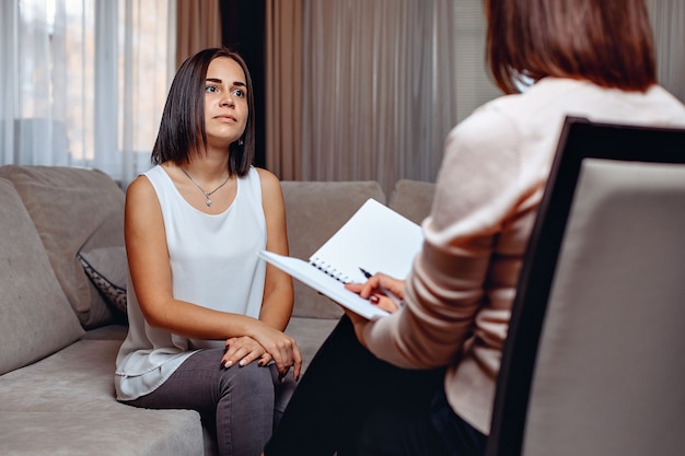 Beautiful worried woman at a psychologist appointment. Psychological problems. Mental problems  