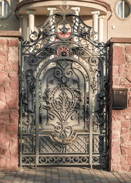 beautiful wrought iron wicket door made of dark metal