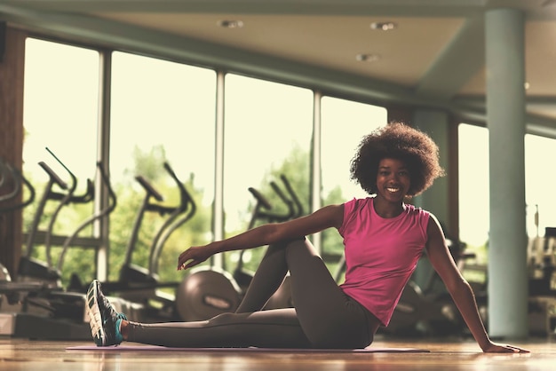 Beautiful young african american woman exercise yoga in\
gym