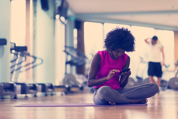 Beautiful young african american woman exercise yoga in\
gym