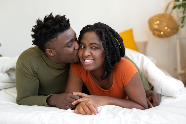 beautiful young african couple lie on the bed