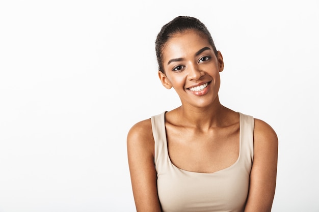 Beautiful young african woman casually dressed standing isolated, posing