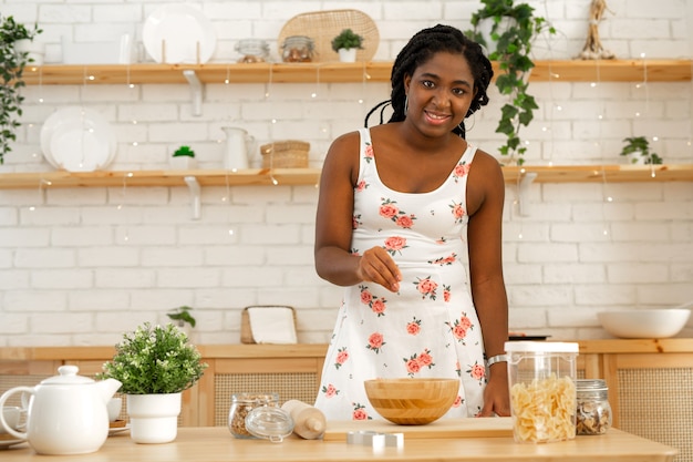 beautiful young african woman cooking in the kitchen